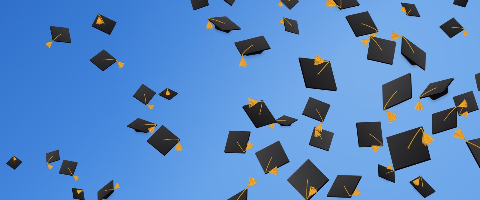 Graduation caps with gold tassels flying across a blue sky