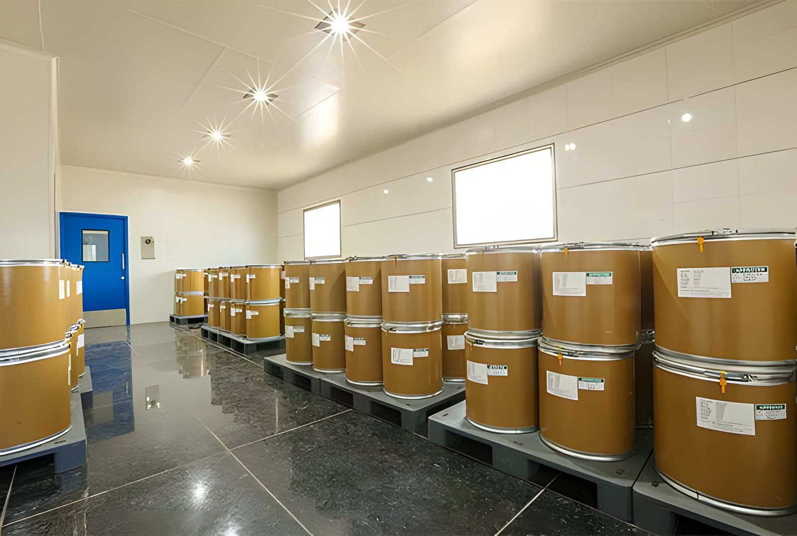Labelled fibre drums on pallets in a finished goods store