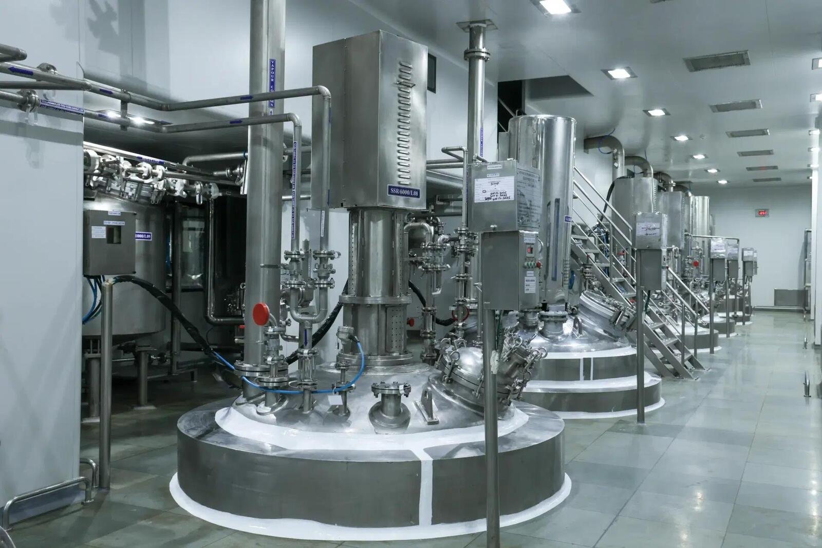 Row of stainless steel reactors in a manufacturing block