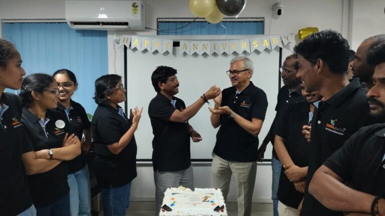 Cutting the cake at the company anniversary celebration